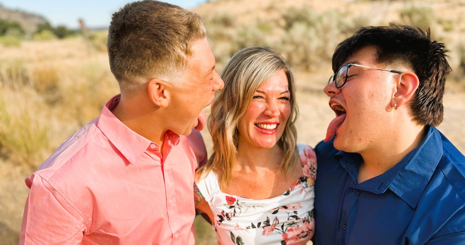 Lindsey Estes laughing as her two sons kiss her cheeks